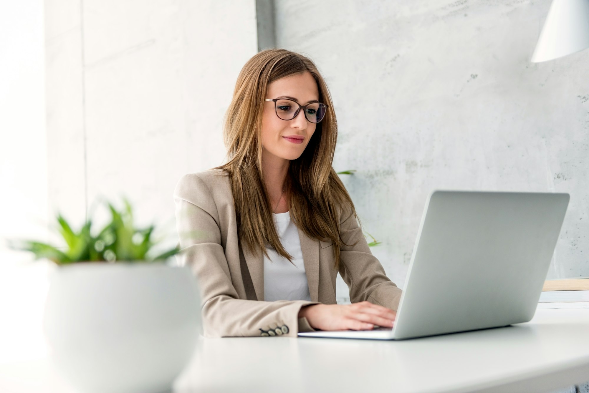 Businesswoman typing on laptop
