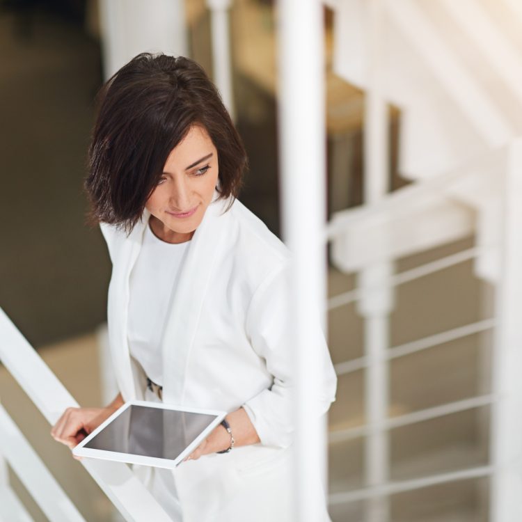Shot of a young businesswoman standing with a digital tablet in an office
