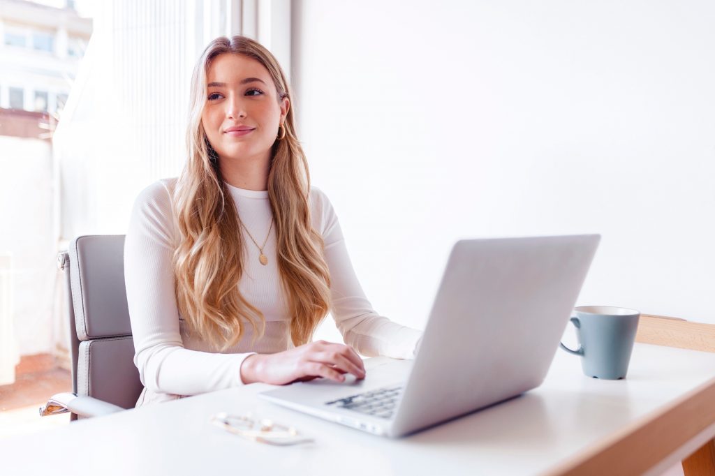 Blond woman working on her laptop at the office