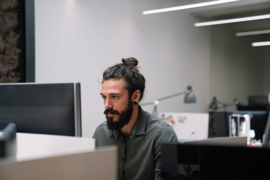 Tired exhausted man, office worker, manager or freelancer, working in office