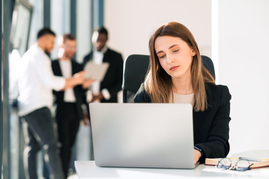 Beautiful office woman working on laptop in the office
